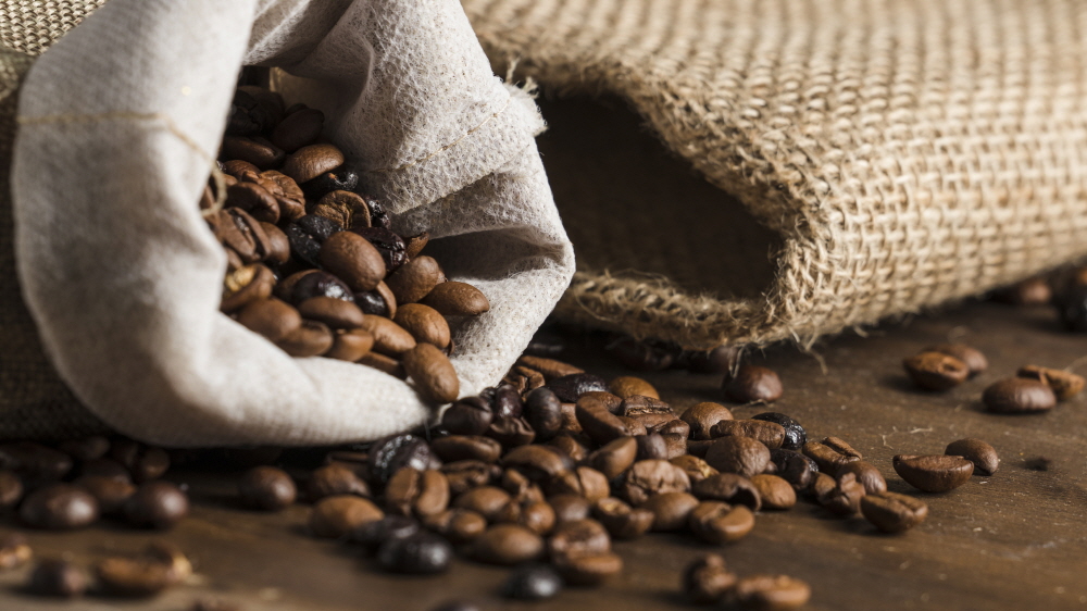 크기변환책상 위에 커피콩이 있는 무료 사진 자루